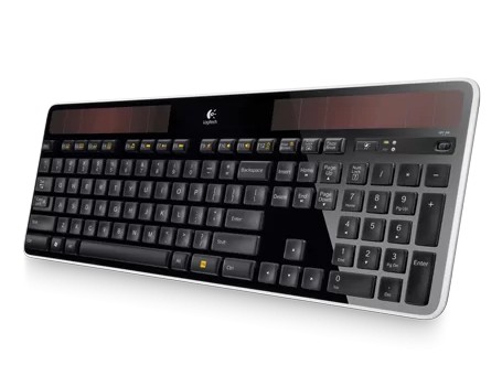 Gambar keyboard Logitech K750 yang tipis dan bertenaga surya diletakkan di dekat jendela, menampilkan panel suryanya, dengan sedikit sinar matahari yang menyinarinya.