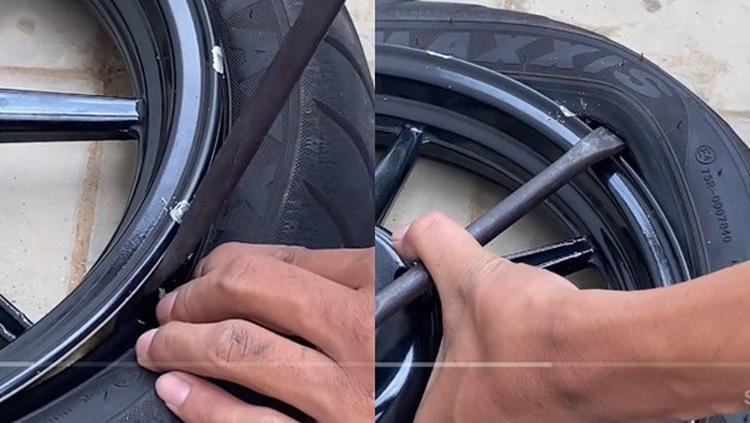 Montir sedang memperbaiki ban sepeda motor