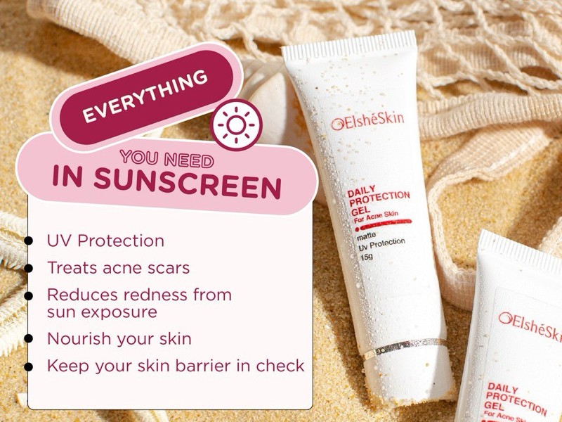 Gambar tube ElshéSkin Daily Protection For Acne Sunscreen, menampilkan estetika bersih dan profesionalnya, mungkin dengan sedikit petunjuk tekstur mineralnya, dengan latar belakang samar Surabaya.