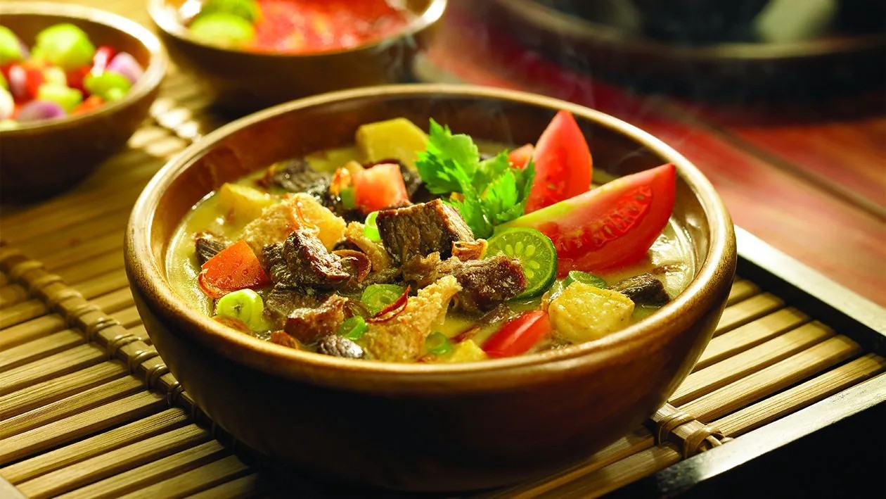 Semangkuk soto Betawi dengan kuah kental dan potongan daging.