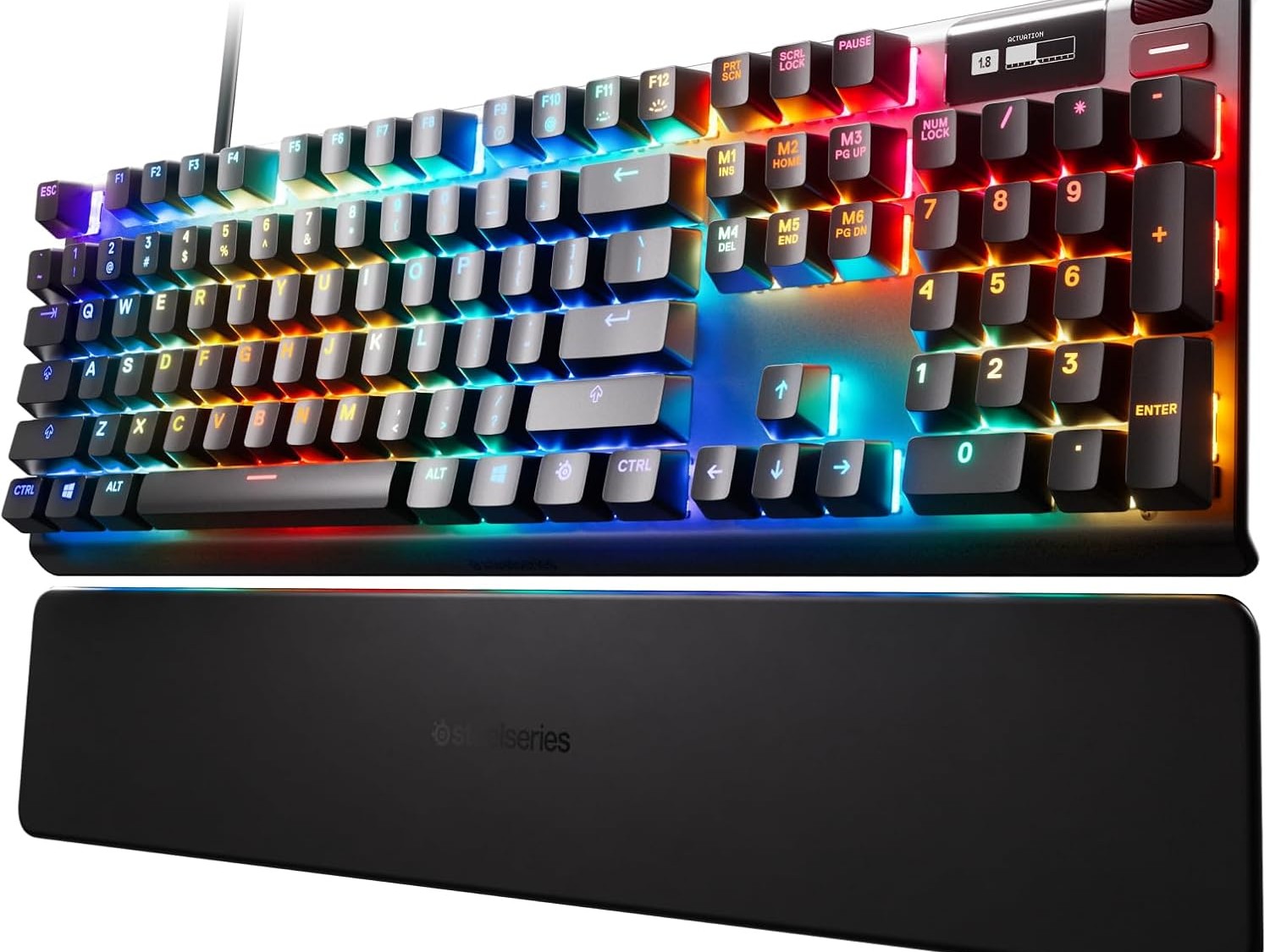 Gambar keyboard SteelSeries Apex Pro, diperbesar pada layar OLED kecilnya, menampilkan statistik game atau notifikasi Discord di layar.