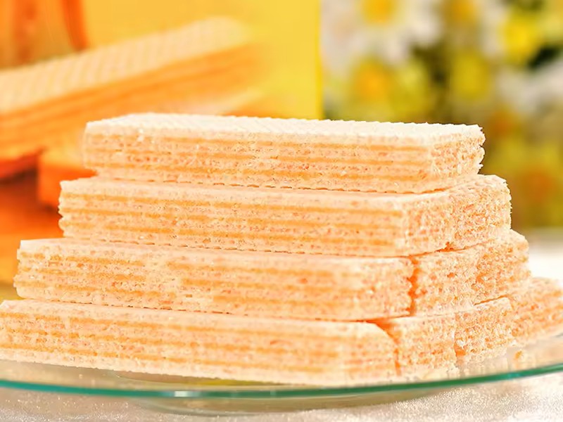 Gambar tumpukan wafer Nabati dengan berbagai rasa (keju, cokelat) yang sudah terbuka kemasannya.