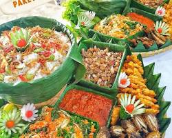 Meja makan penuh dengan aneka masakan Sunda rumahan seperti ayam goreng, sayur asam, dan pepes.