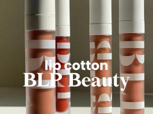 Gambar tube BLP Beauty Lip Cotton dengan desain minimalis dan ramping khasnya, menonjolkan estetika lembut dan natural, mungkin dengan berbagai olesan lipstik nude, dengan latar belakang samar Grand I