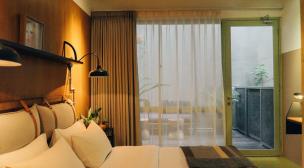 Interior kamar tidur di The House Tour Hotel Bandung dengan gaya Scandinavian.