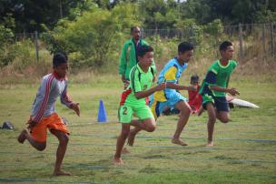 Gambar siswa-siswi sedang berlari di jalur atletik sekolah atau melakukan peregangan di lapangan terbuka.